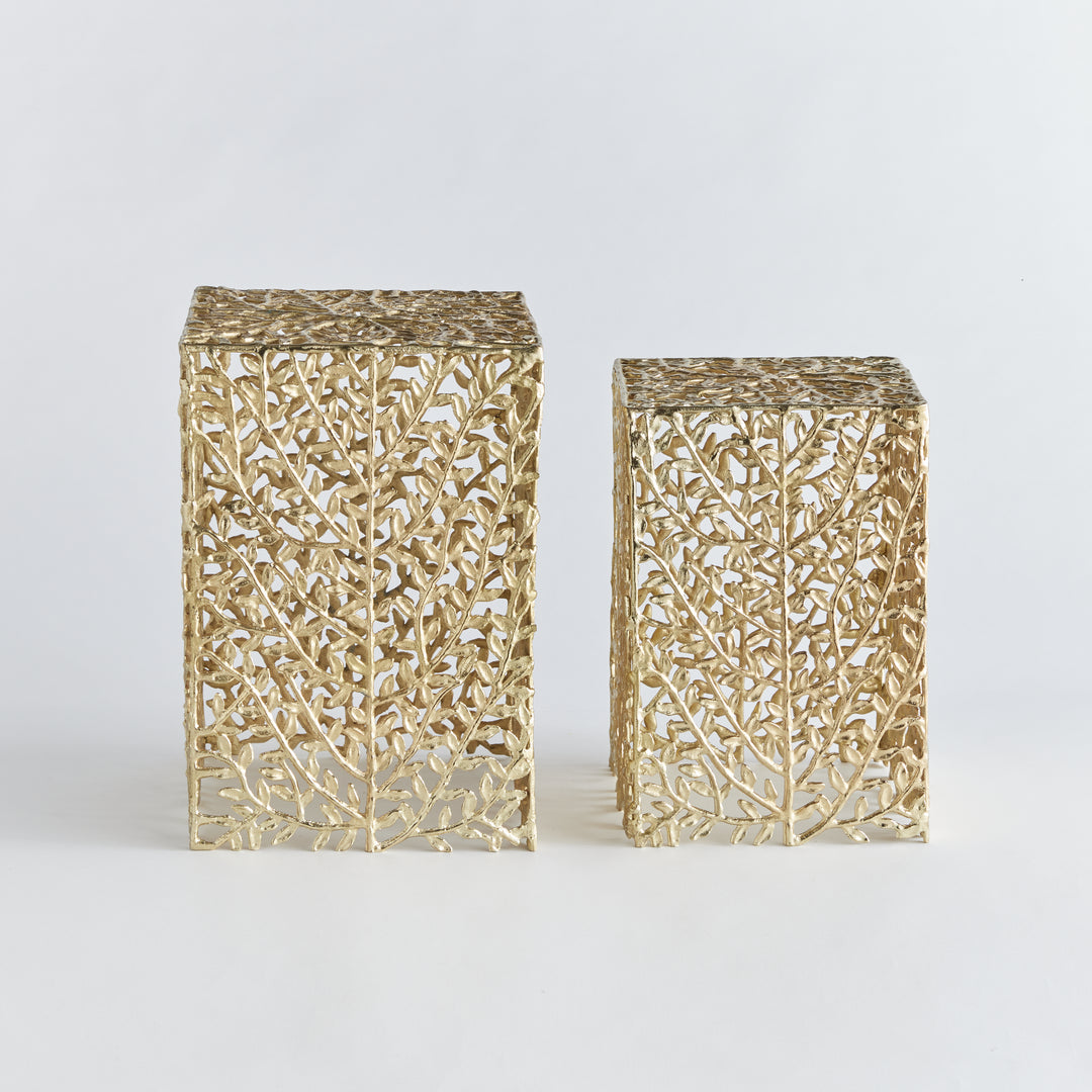 Front view of two gold metal vine side tables with intricate botanical cutouts
