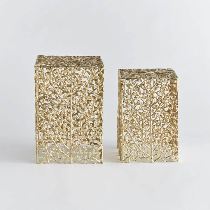 Front view of two gold metal vine side tables with intricate botanical cutouts

