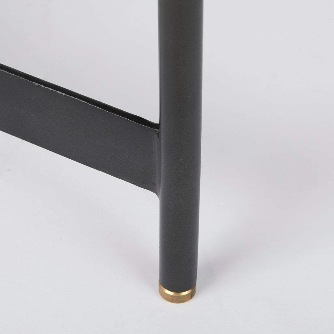 Close-up of black iron table leg with gold metal cap and smooth mango wood tray edge – Modern Organic