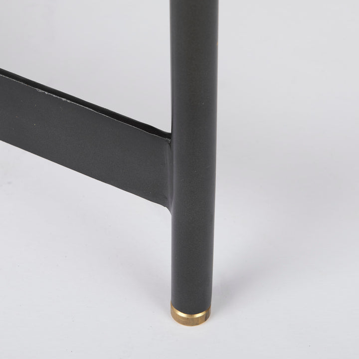 Close-up of black iron table leg with gold metal cap and smooth mango wood tray edge – Modern Organic