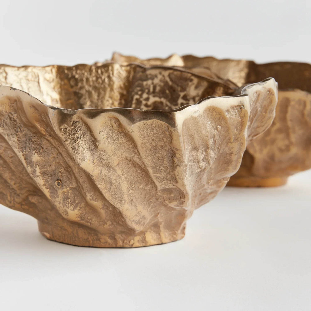 Gold cast aluminum decorative bowl with sculptural edge and deep profile, side view of shell form tabletop accent – Modern Organic
