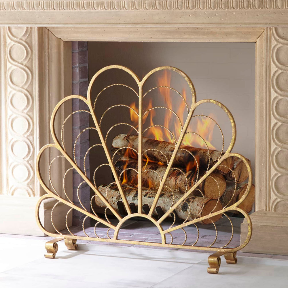Shell-style fireplace screen in Italian gold styled in marble fireplace for coastal luxury ambiance.

