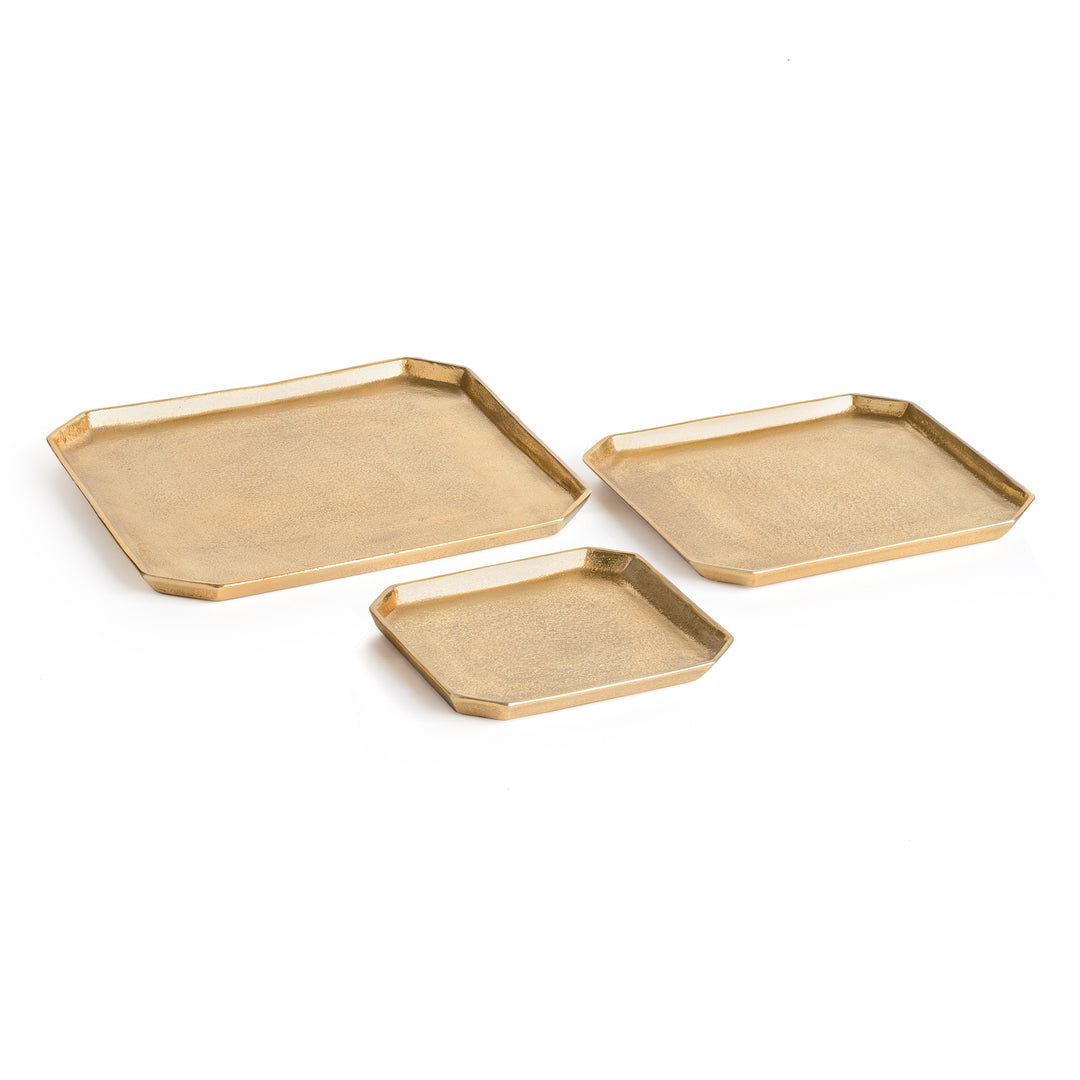 Set of three gold square cast aluminum serving trays with clipped corners and textured surfaces on white, Transitional style