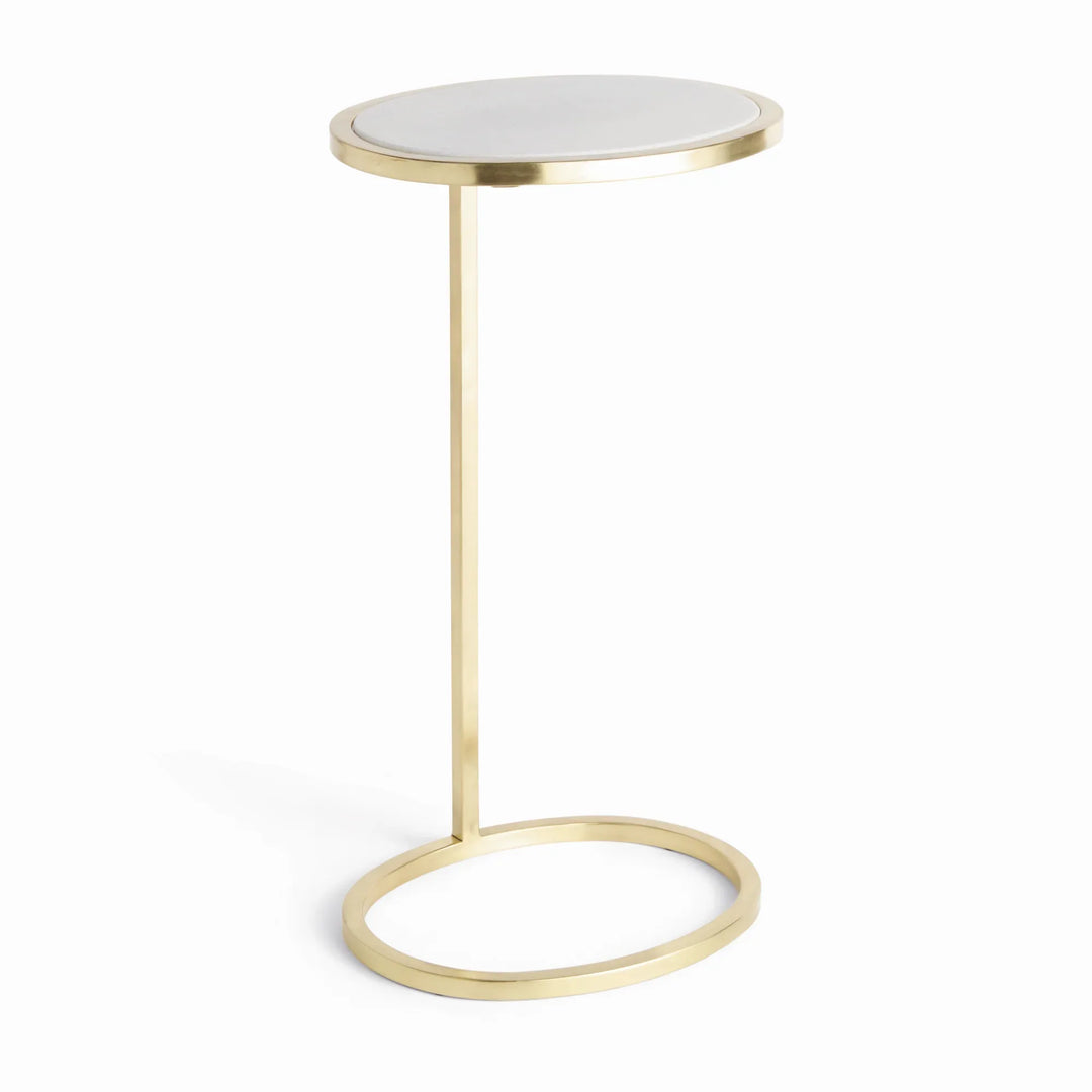 Gold steel accent table with white oval marble top and open ring base shown full view beside seating Modern Glam style