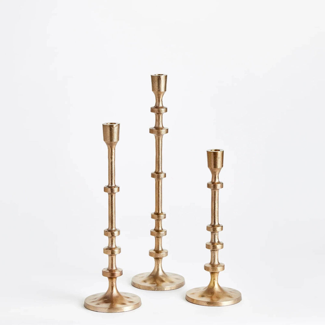 Gold taper candle holder stem showing sculptural notched rings and metallic finish – Modern.