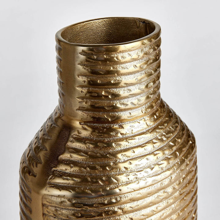 Closeup of rim on gold aluminum vase, showing warm metallic finish and handcrafted texture

