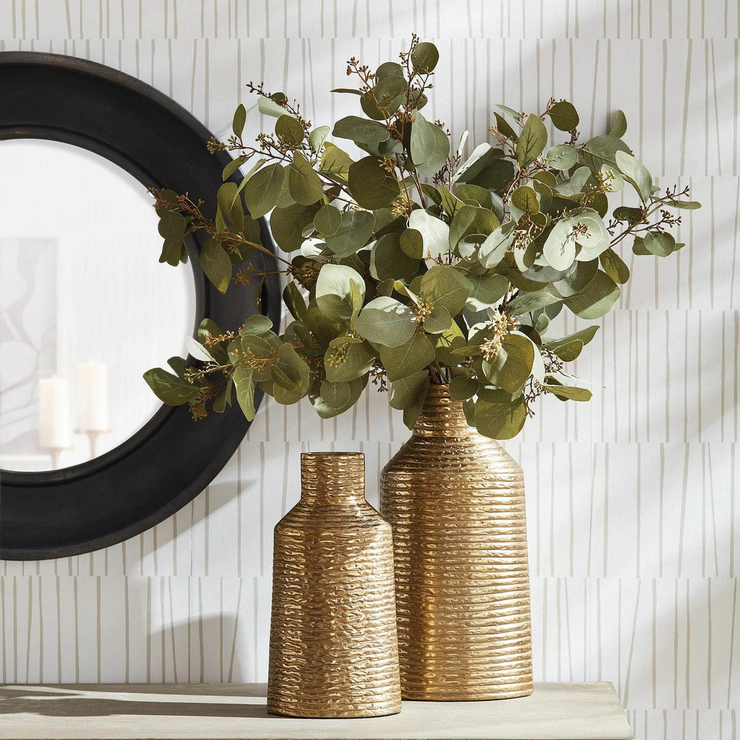 Gold textured aluminum vase styled with faux greenery on console, modern classic warm metallic decor

