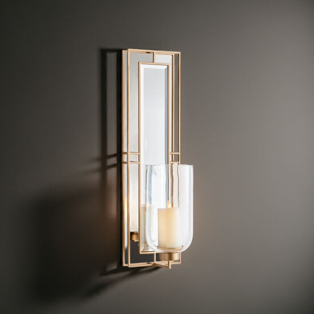 Gold wall sconce with glass hurricane and mirrored back panel, 28 inch tall, shown lit with LED candle for warm ambient glow – Transitional décor.