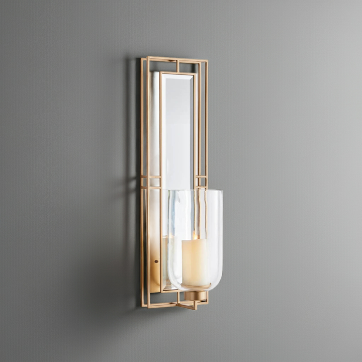 Champagne gold wall sconce with mirrored back and glass hurricane, 28 inches tall, mounted on wall with LED candle – Transitional décor.
