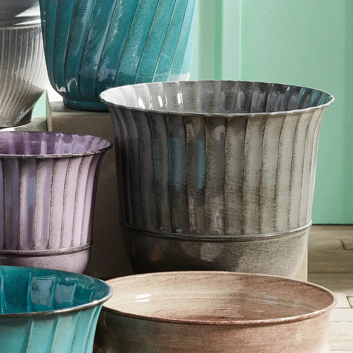 Modern Organic gray planter set displayed with colorful companion pots and green wall