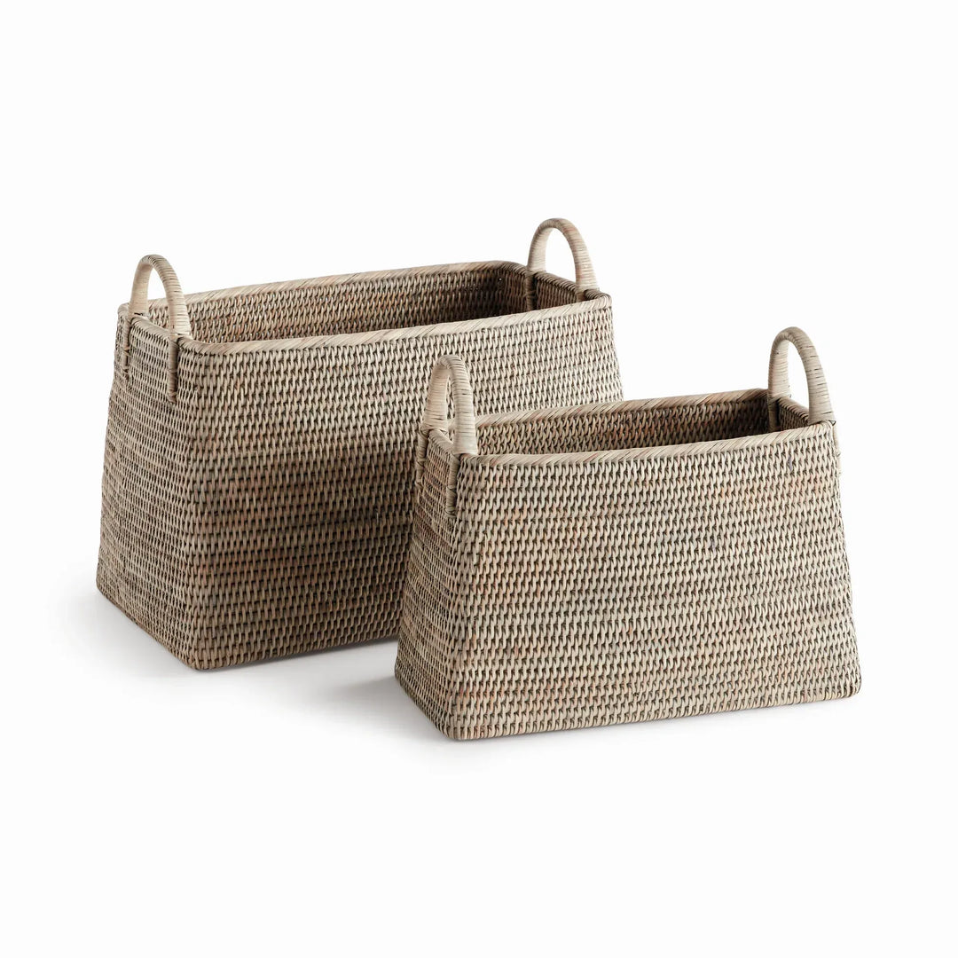 Two graywash handwoven rattan magazine baskets with loop handles and narrow rectangular bodies, shown on white, Transitional