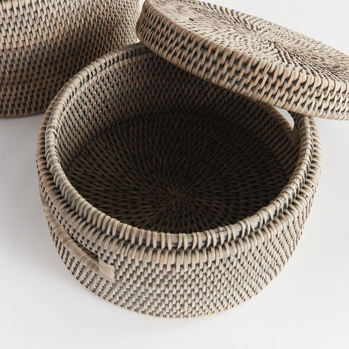 Overhead view of an open graywash rattan box showing its tightly woven interior with the matching lid lifted, Transitional