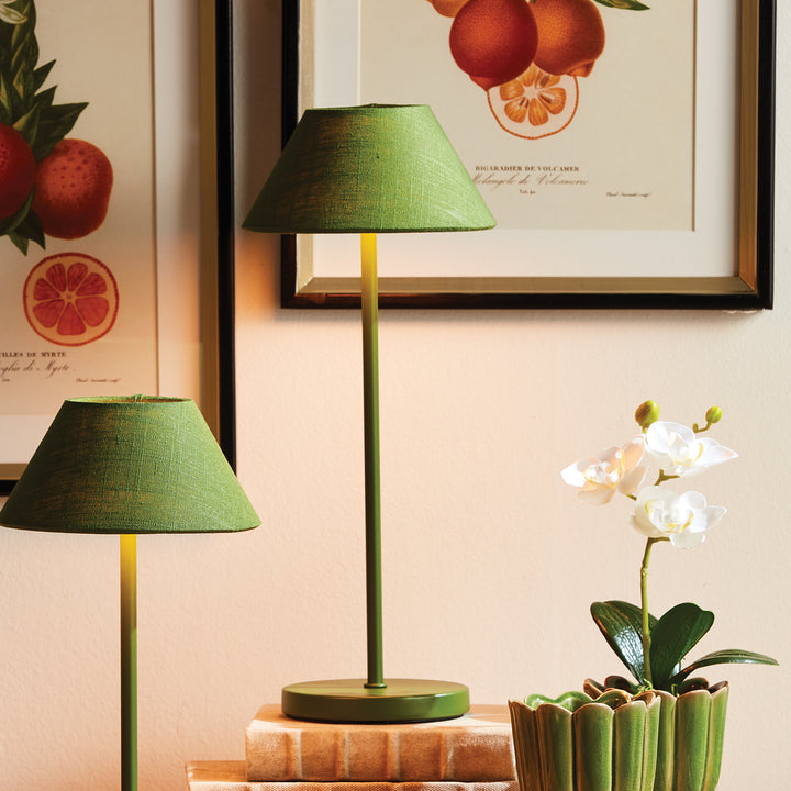 Dark green cordless LED table lamp with linen empire shade styled on a console with books and decorative accessories – Coastal Transitional