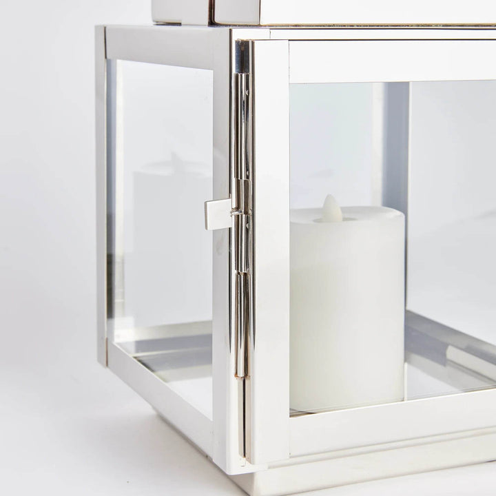 Multiple small coastal silver lanterns with teak handles styled together