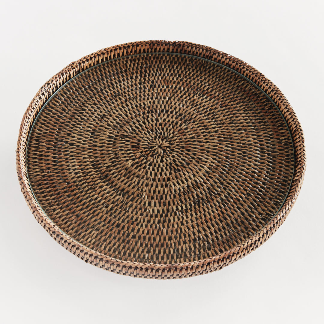 Top view of Hadley warm brown rattan stand showing the glass insert above a radiating pattern within the round rim. Coastal