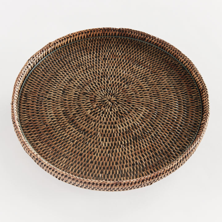 Top view of Hadley warm brown rattan stand showing the glass insert above a radiating pattern within the round rim. Coastal