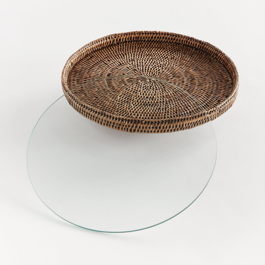 Hadley warm brown rattan stand with its removable round glass insert placed separately beside the raised platform. Coastal
