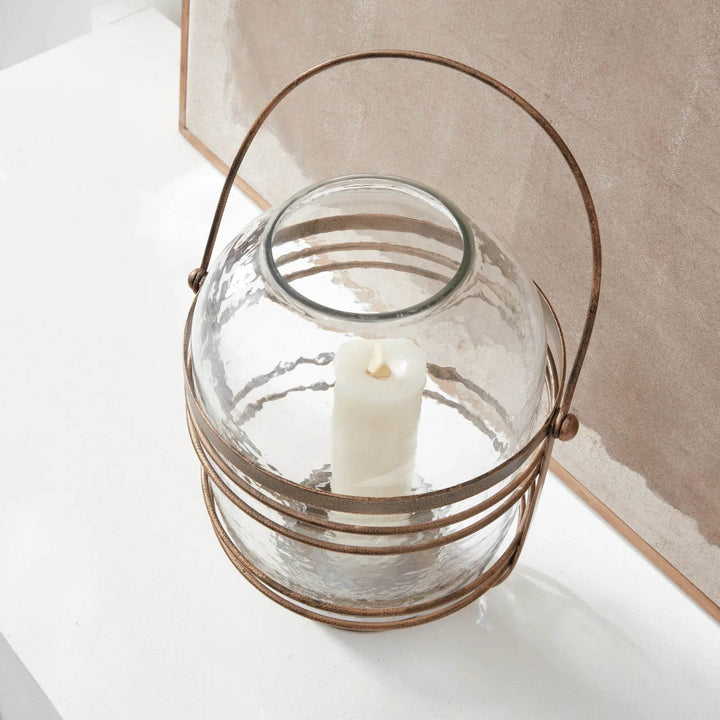 Top view detail of hammered glass hurricane with opening and antique gold rim, round vessel designed for candles – Coastal