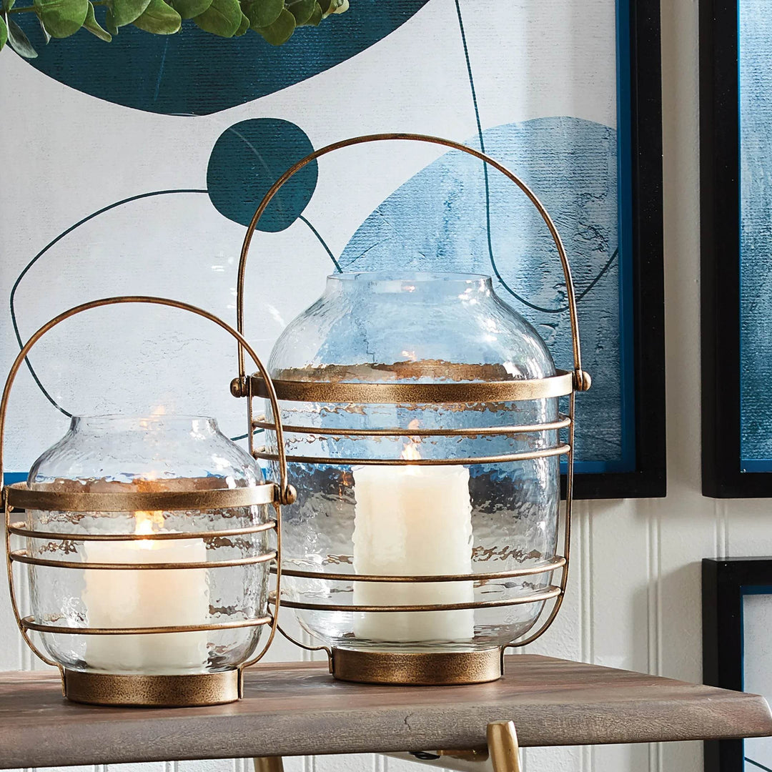 Pair of hammered glass hurricanes with antique gold iron bands and handles, arranged on console for styled vignette – Coastal