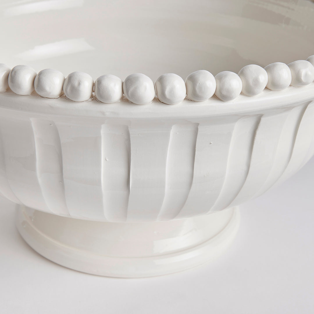Close-up of hand-applied beaded rim on white ceramic coastal transitional bowl