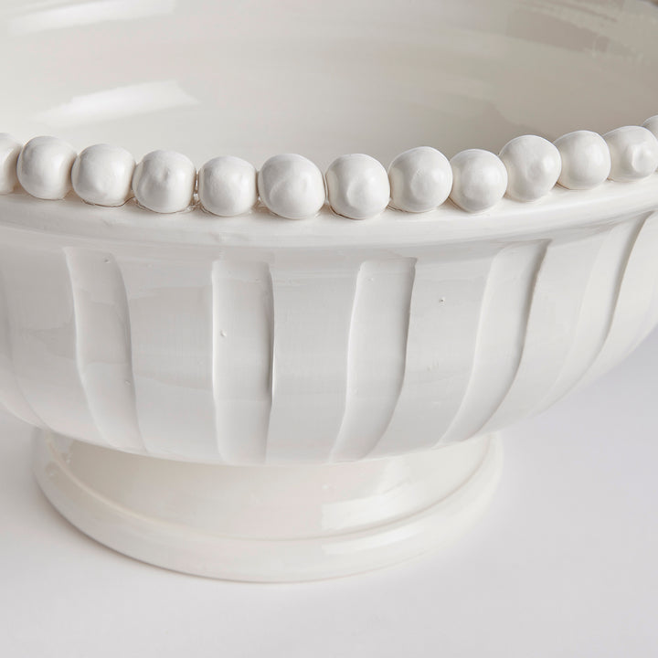 Close-up of hand-applied beaded rim on white ceramic coastal transitional bowl