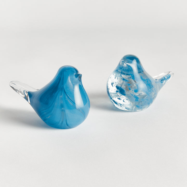 Hand blown blue glass finch sculptures set of two with rounded bird forms, decorative tabletop accents for shelves, consoles, or tables.