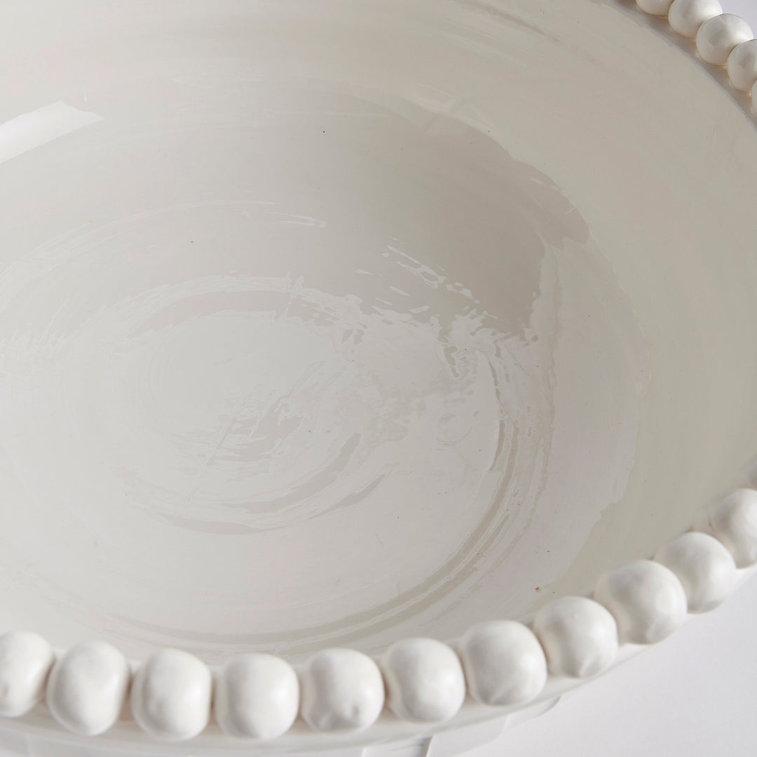 Close-up of interior hand-glazed white ceramic bowl showing spiral texture and glaze variation