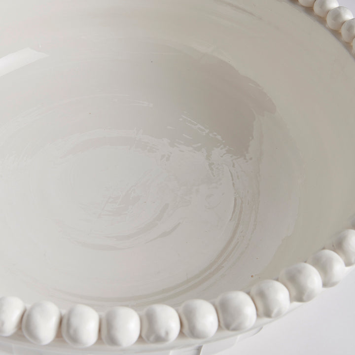 Close-up of interior hand-glazed white ceramic bowl showing spiral texture and glaze variation