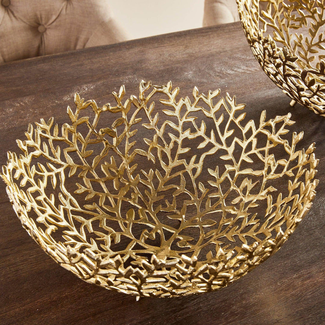 Pair of sculptural gold vine bowls styled as tabletop decor, showcasing modern botanical design elements.