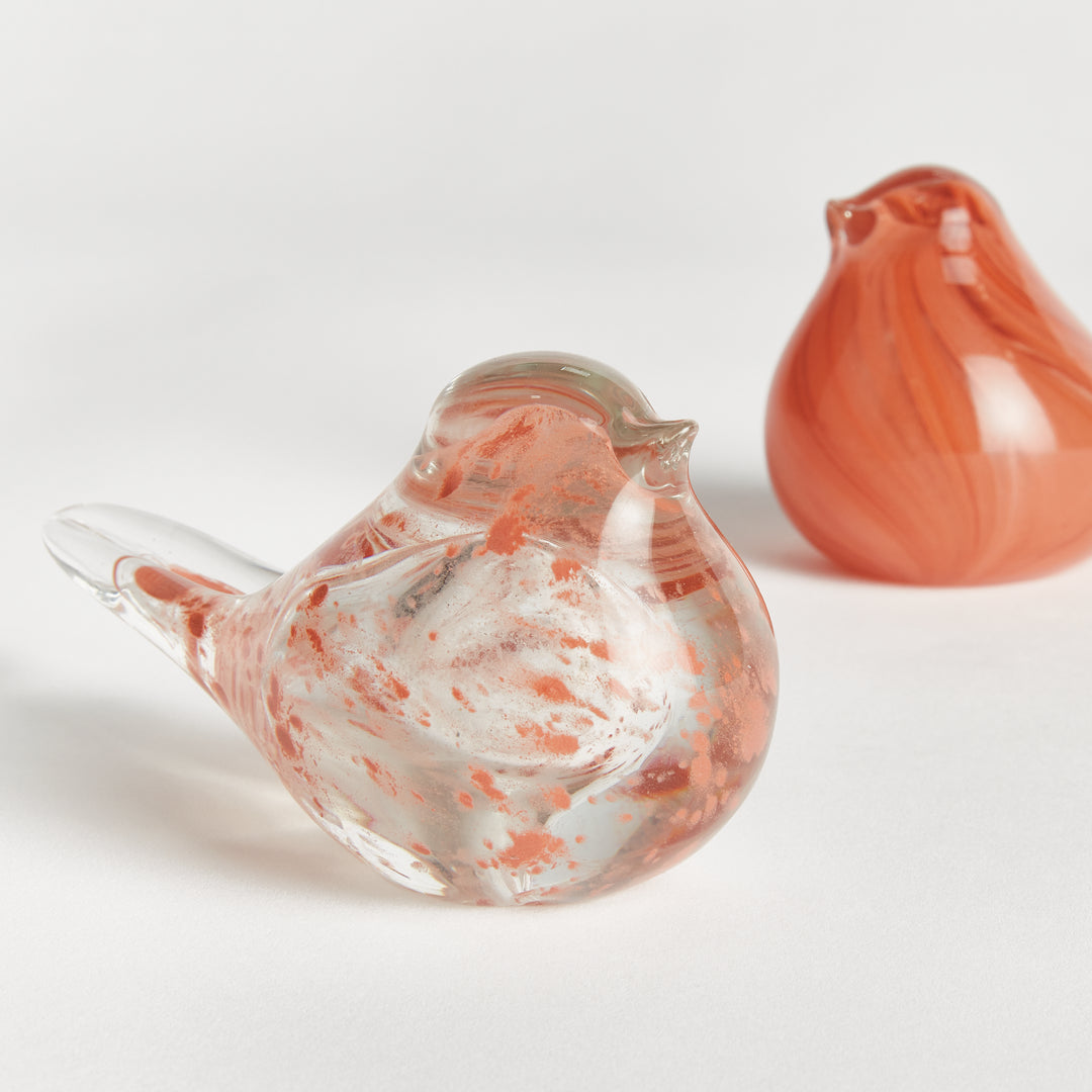 Handcrafted melon glass finch sculptures set of two with smooth rounded shapes, decorative bird accents for interiors.