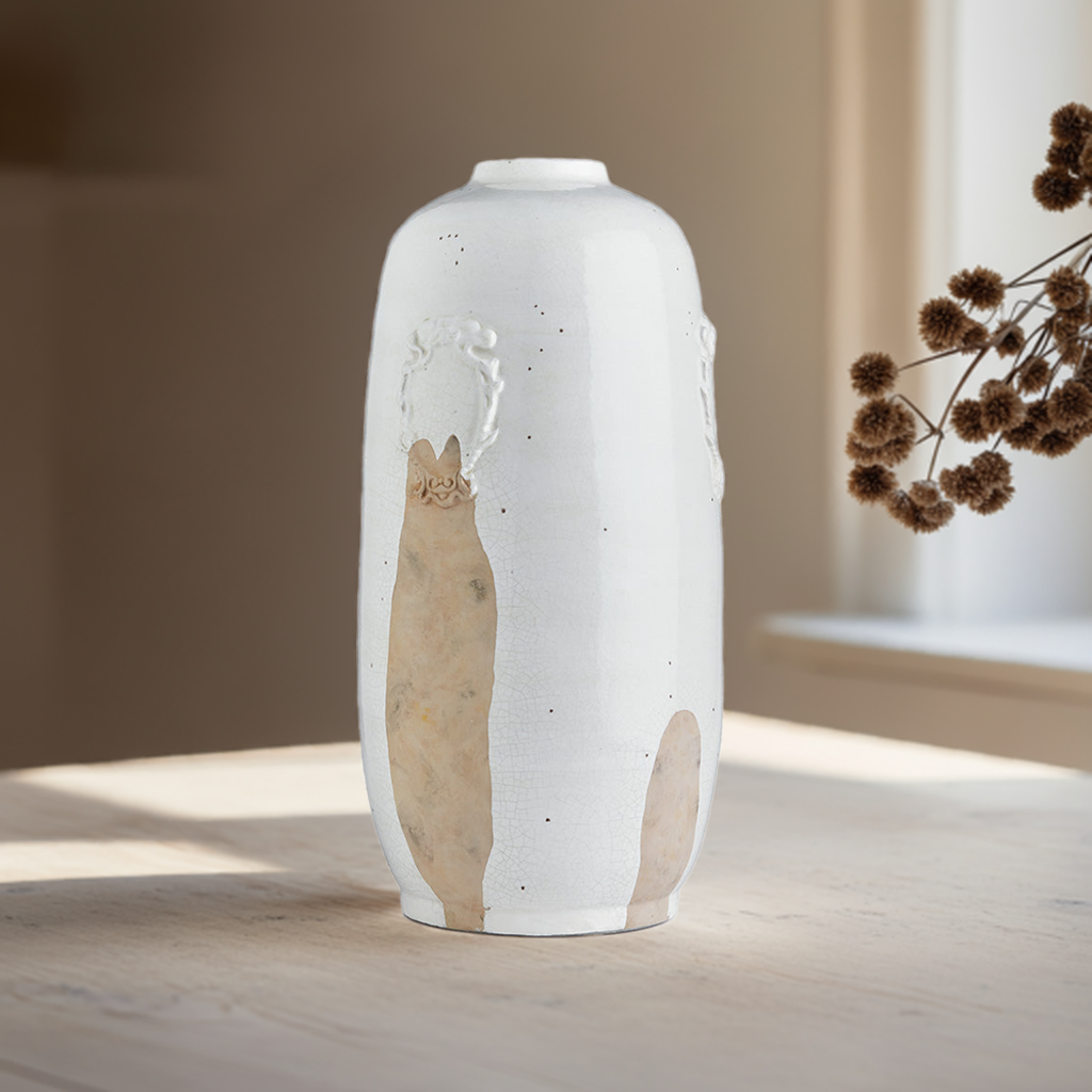 Handcrafted tall white ceramic vase with exposed clay detail shown from front angle, ideal for console or mantel styling.

