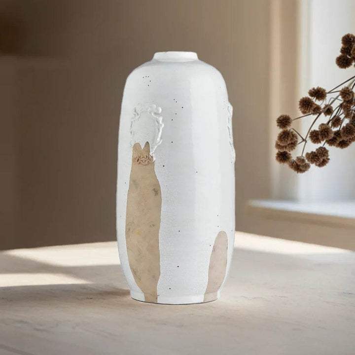 Handcrafted tall white ceramic vase with exposed clay detail shown from front angle, ideal for console or mantel styling.

