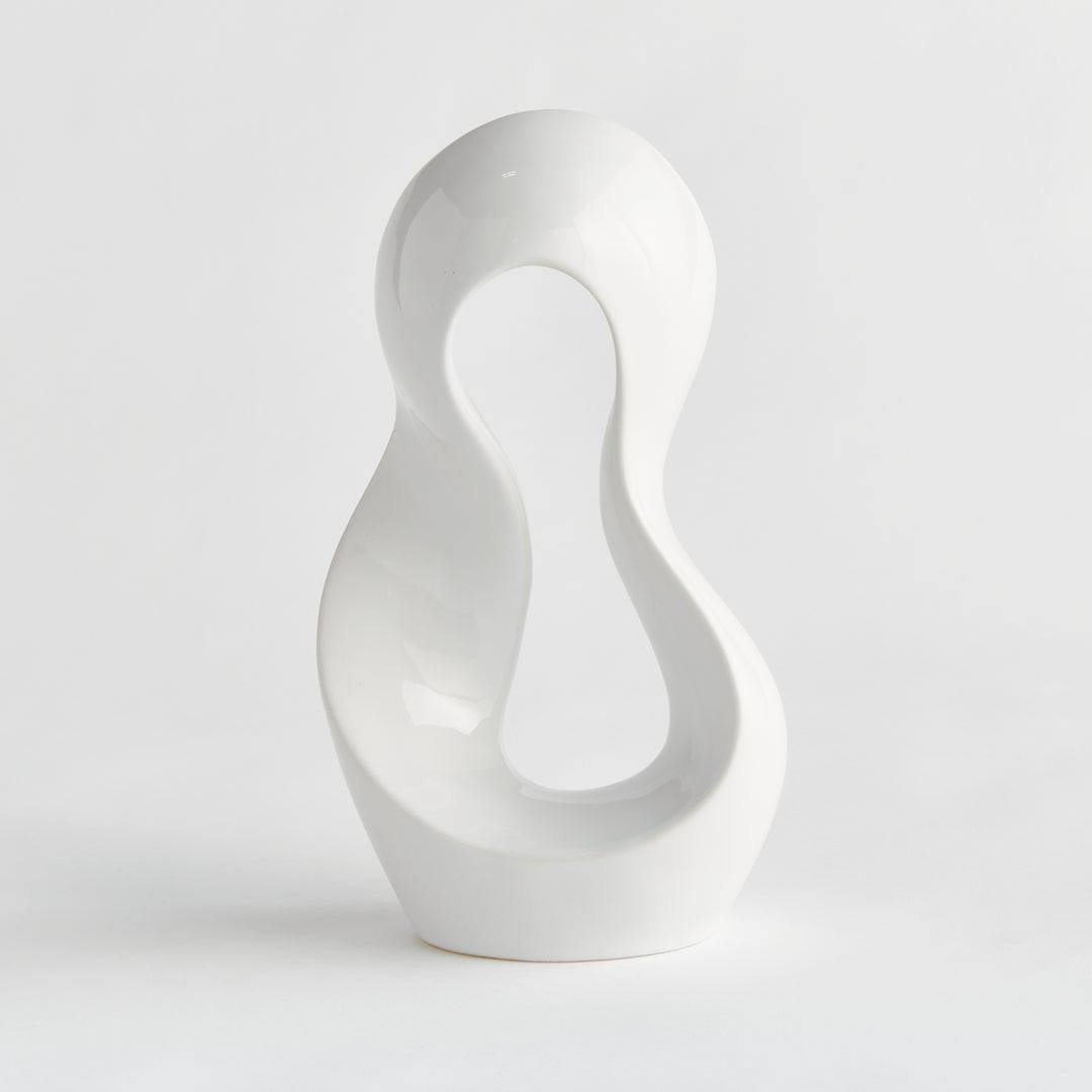 Glossy white clay sculpture shown from front angle against a white background, highlighting full curved silhouette and open interior design.