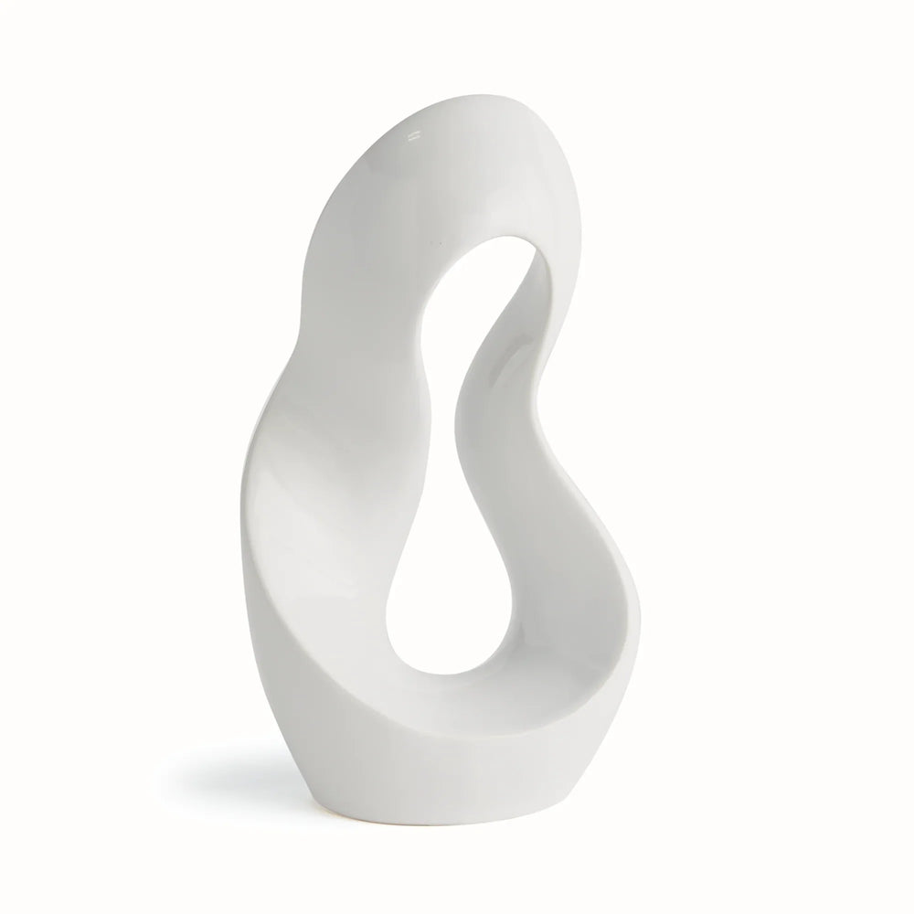 Three-quarter side view of abstract clay sculpture in alabaster gloss finish, showing organic arc shape and sculptural negative space.