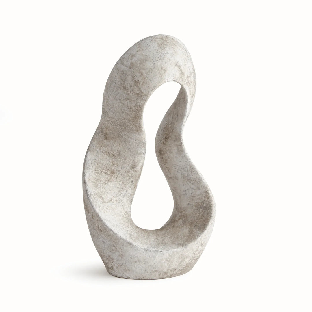 Three-quarter angle of sculptural clay form with open interior and soft curves, highlighting texture and dimensionality of the clay body.