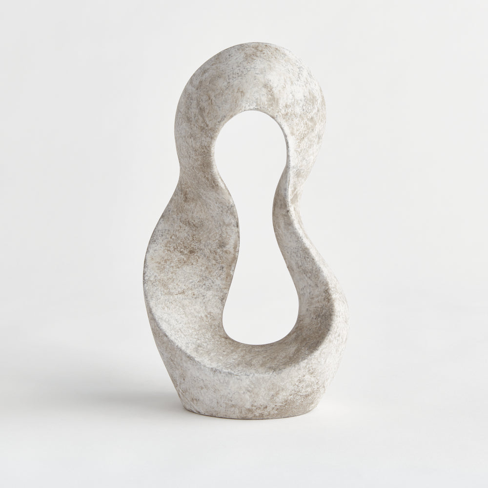 Full frontal view of abstract curved clay sculpture with negative space center and matte earthstone surface, captured in even studio light.