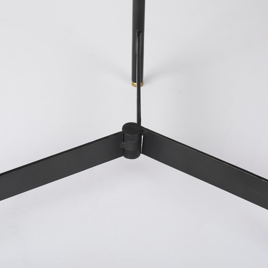 Close-up of black iron tripod base showing intersecting supports and clean metal construction – Modern Organic