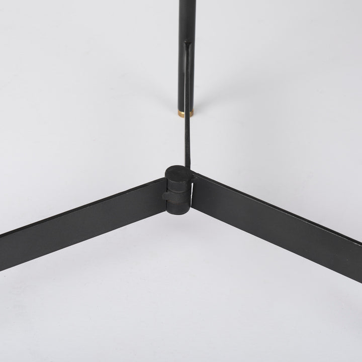 Close-up of black iron tripod base showing intersecting supports and clean metal construction – Modern Organic