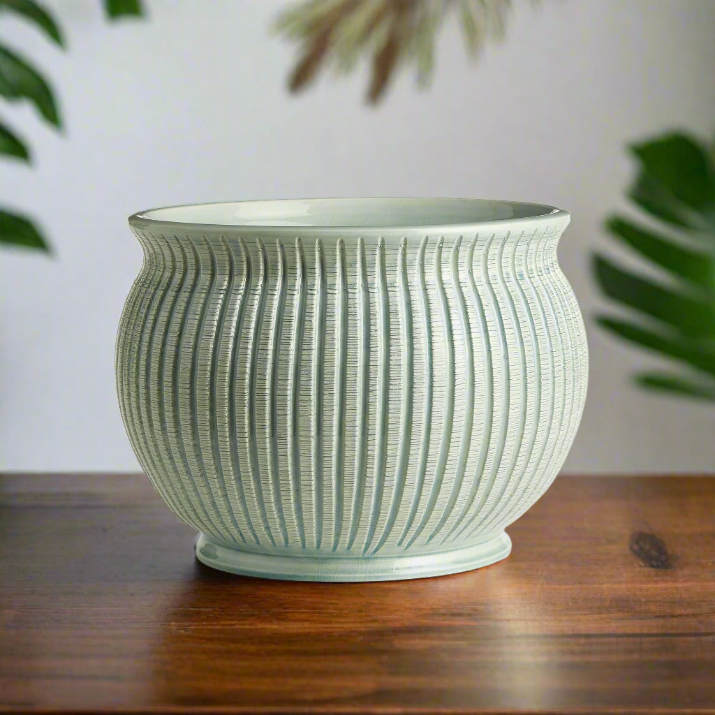 Italian ribbed ceramic cachepot displayed in a Mediterranean-inspired interior.