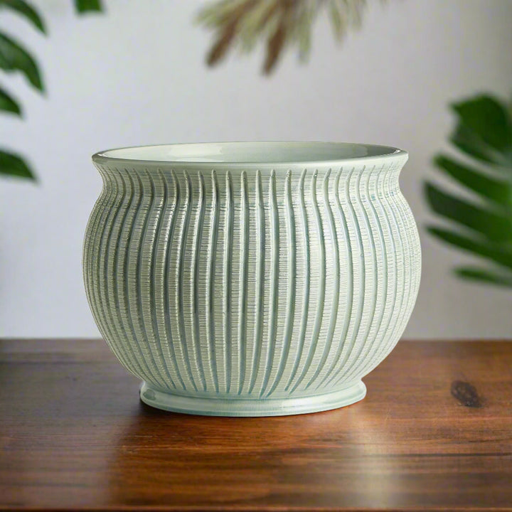Italian ribbed ceramic cachepot displayed in a Mediterranean-inspired interior.