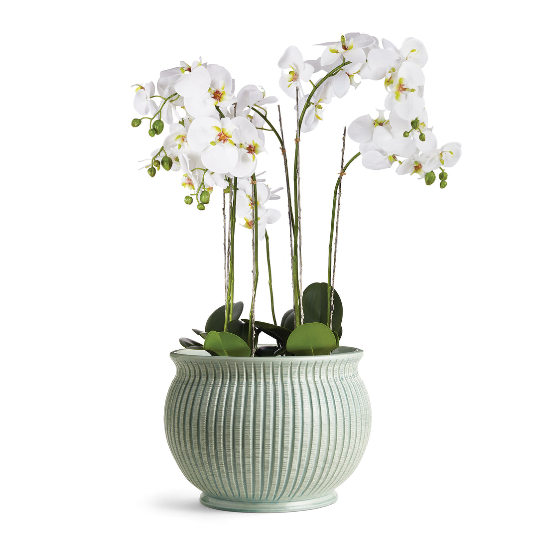 Modern Mediterranean Italian cachepot styled with faux white orchid stems.


