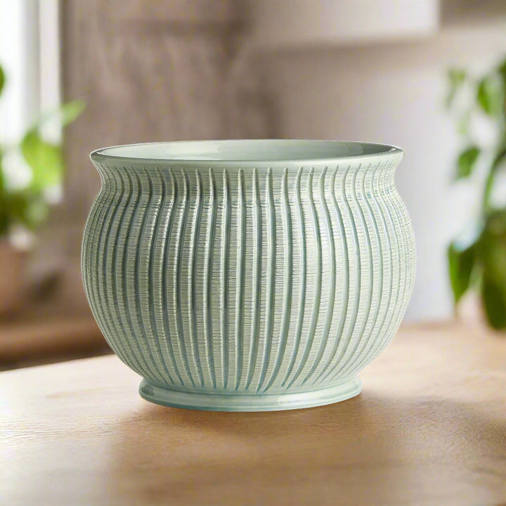 Sculptural side profile of large celadon Italian ceramic cachepot planter.