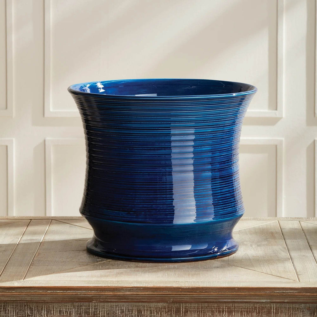 Blue Italian ceramic cachepot vase styled on a wooden tabletop
