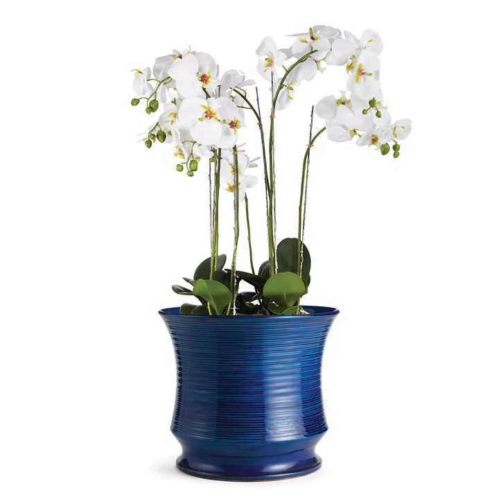 Large Italian ceramic vase used as a cachepot with white orchids

