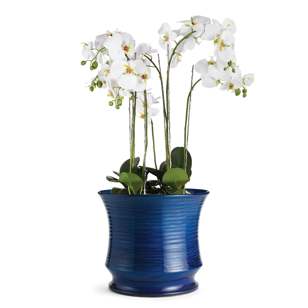 Large Italian ceramic vase used as a cachepot with white orchids

