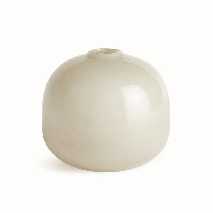 Ivory glass round vase with low curved body, small circular opening and pale neutral tone against white, Modern Organic style