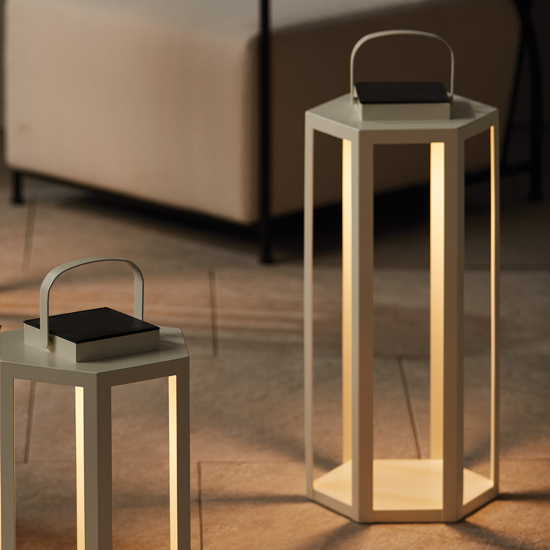 Pair of ivory solar LED lanterns styled together on an outdoor patio creating layered architectural lighting – Modern Coastal