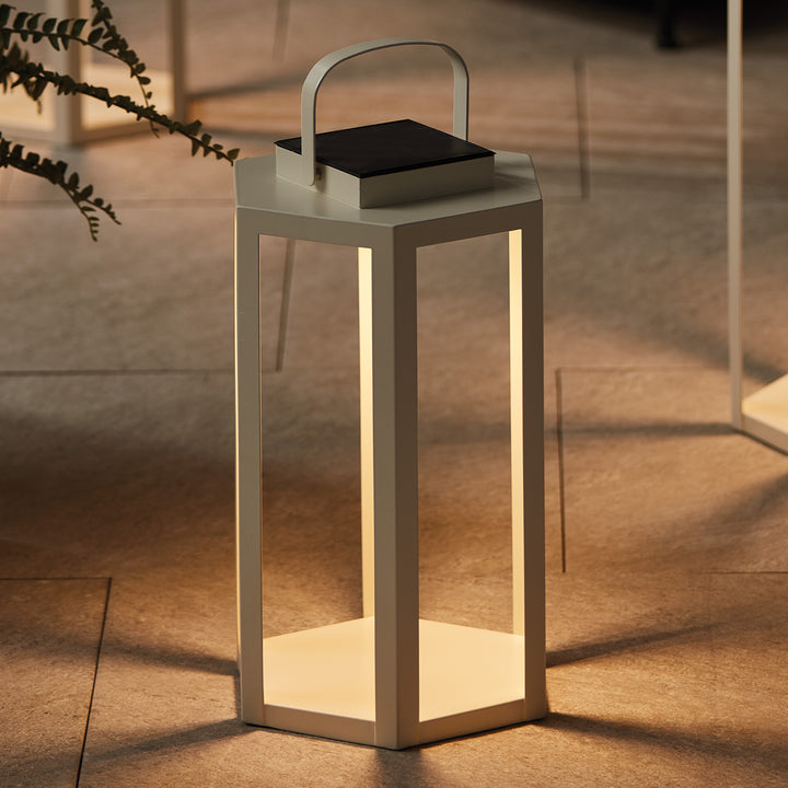 Ivory solar LED lantern illuminating a covered patio with a warm ambient glow for contemporary outdoor living – Modern Coastal