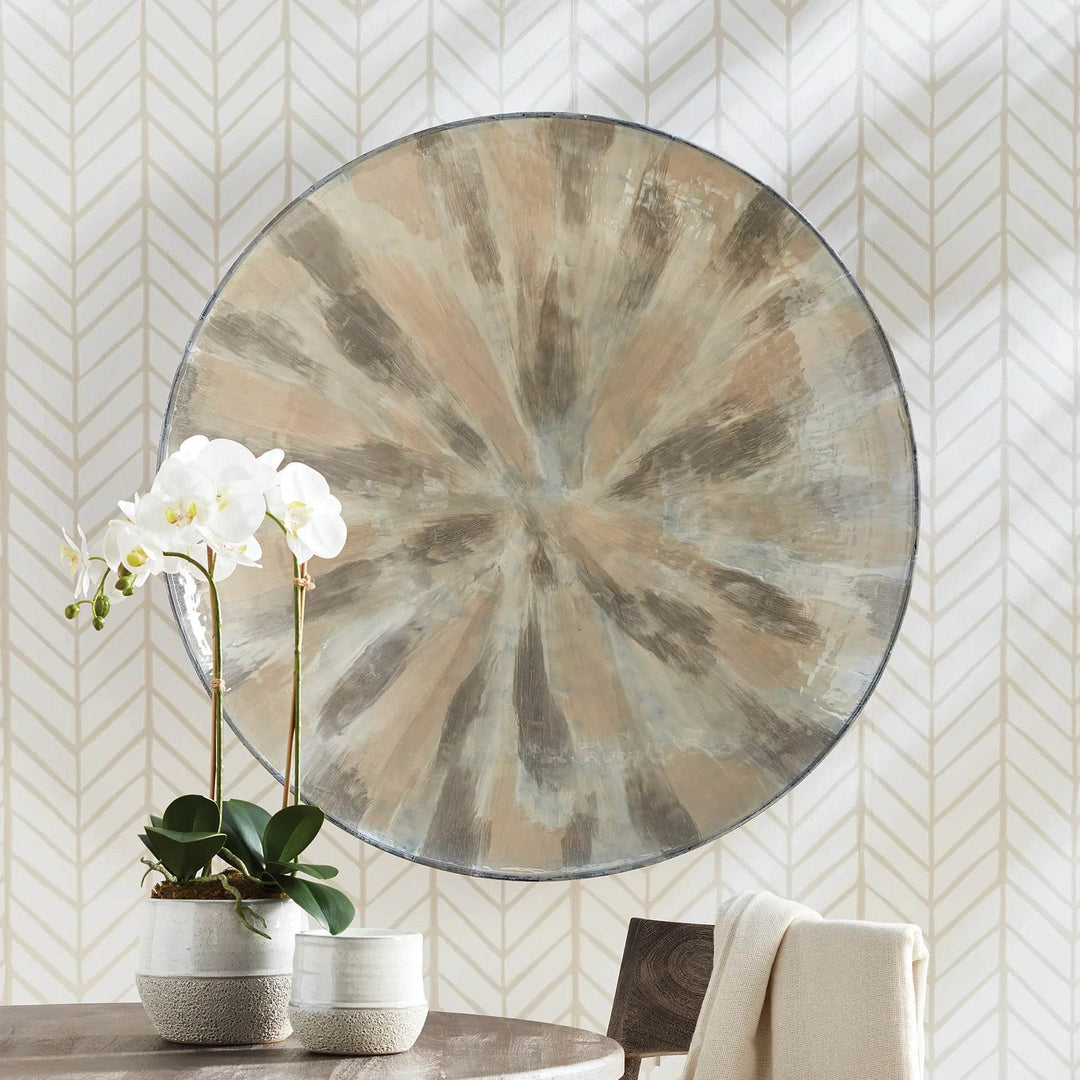 36 inch round enameled iron wall plate with cream and taupe finish, styled above a table with orchid decor – Transitional