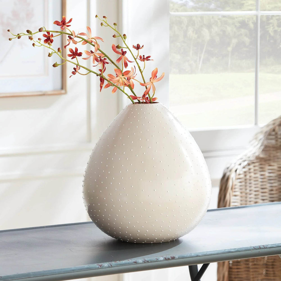 Handcrafted off-white ceramic vase styled with floral stems on console table in bright room – Modern Organic

